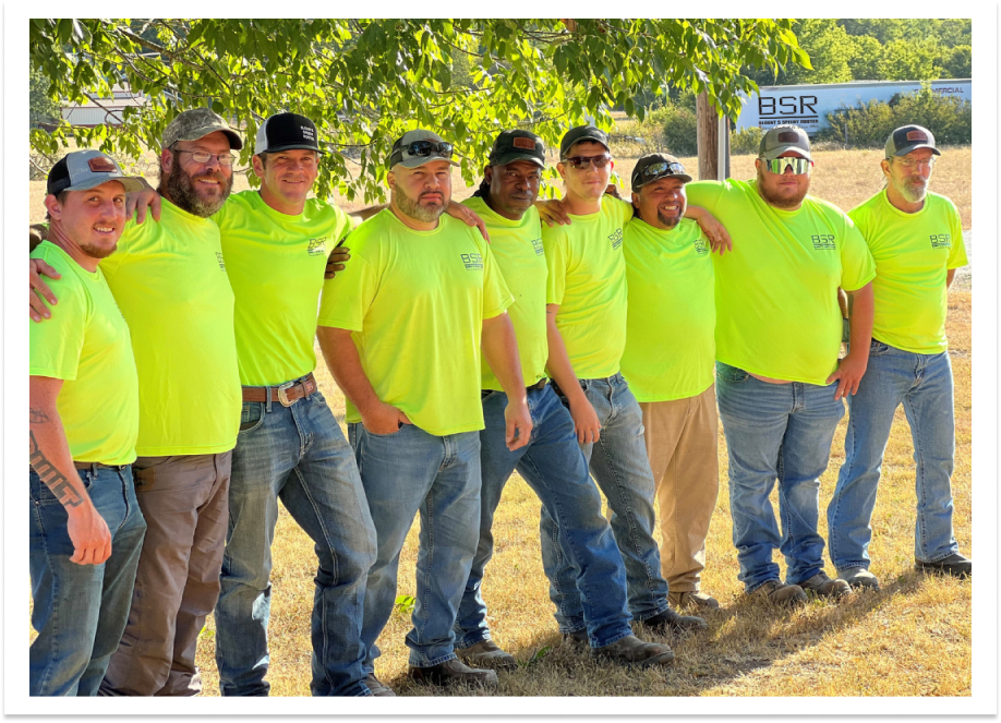 BSR Plumbing employees group photo outdoors wearing neon yellow t-shirts