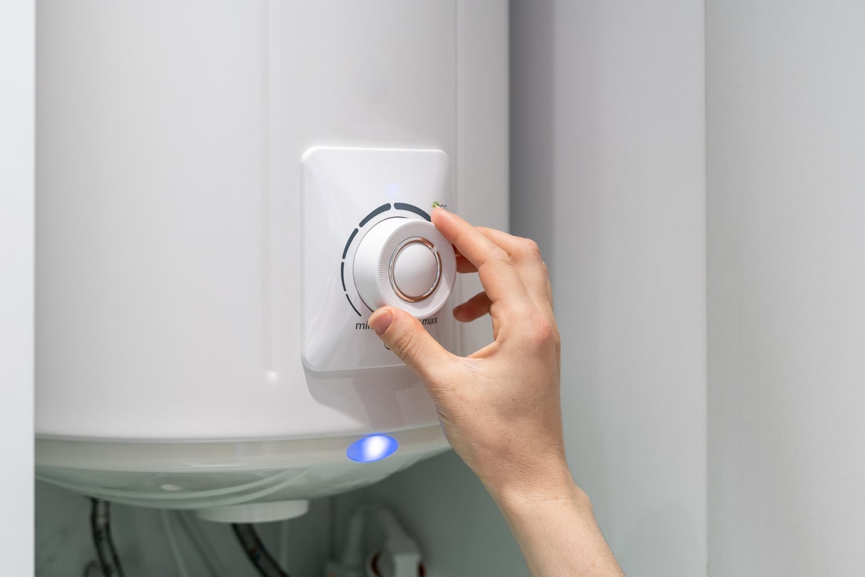 Adjusting the knob on a residential boiler